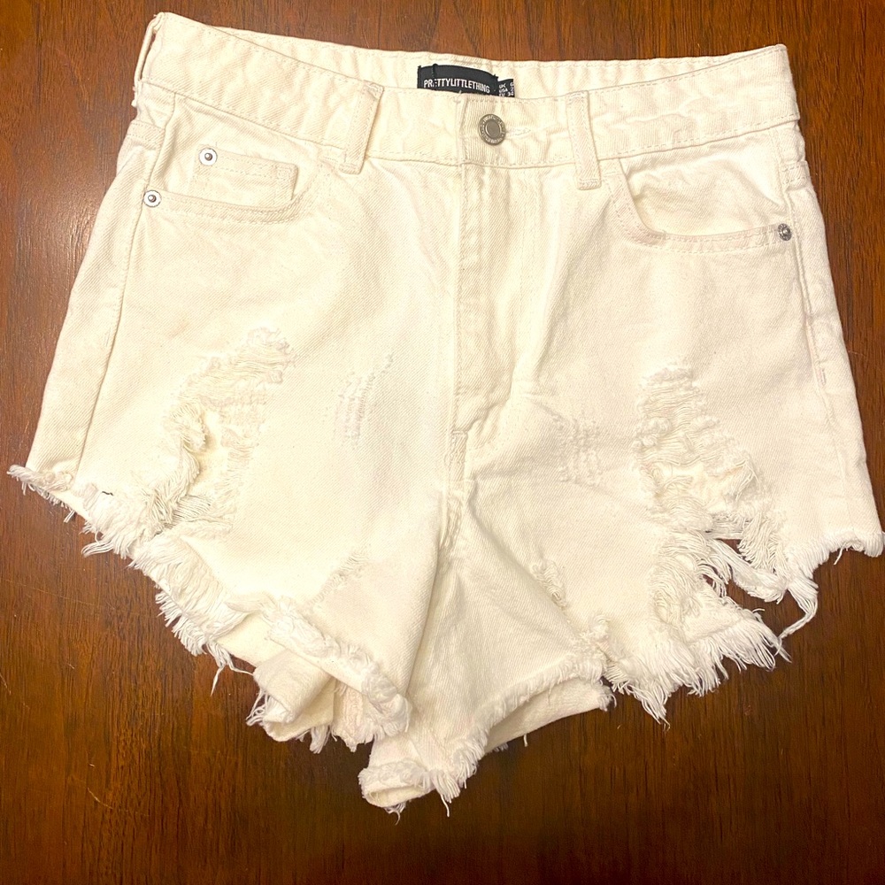NWT. PrettyLittleThing White Thigh Extreme Rip Denim Shorts. Size 2 (USA).